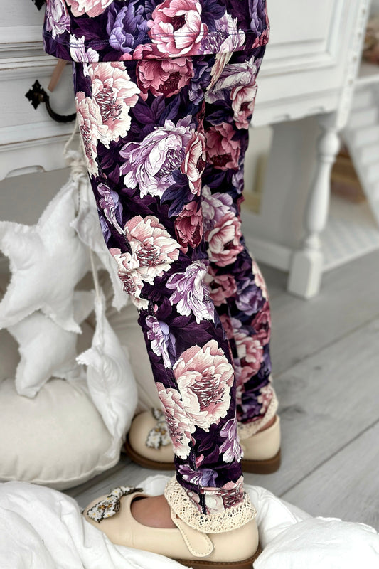 Floral-patterned pants worn by a child in a home setting